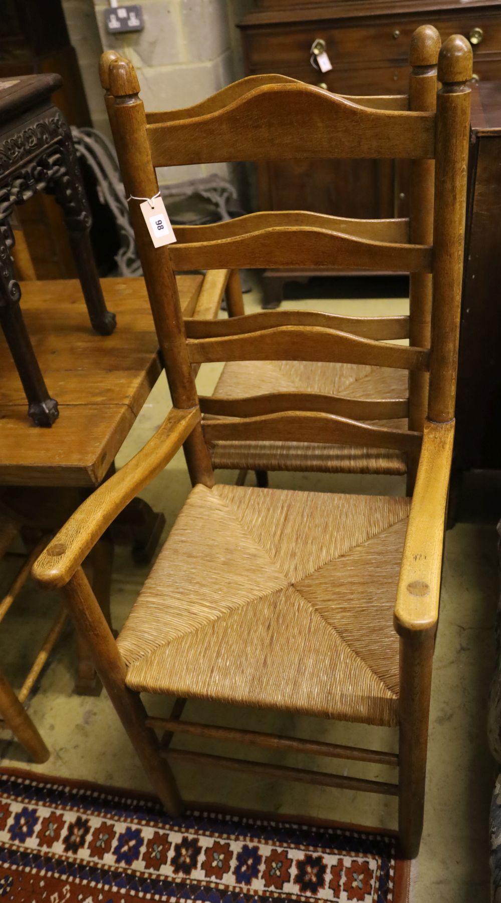 A set of eight ladder back rush seat dining chairs
